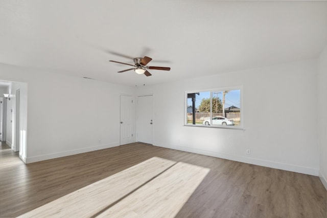 unfurnished room with wood-type flooring and ceiling fan