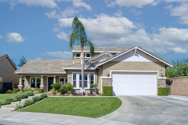 craftsman inspired home with a front lawn and a garage