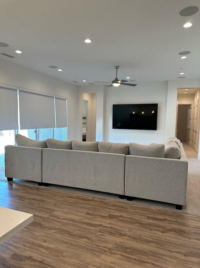 living room with hardwood / wood-style flooring and ceiling fan