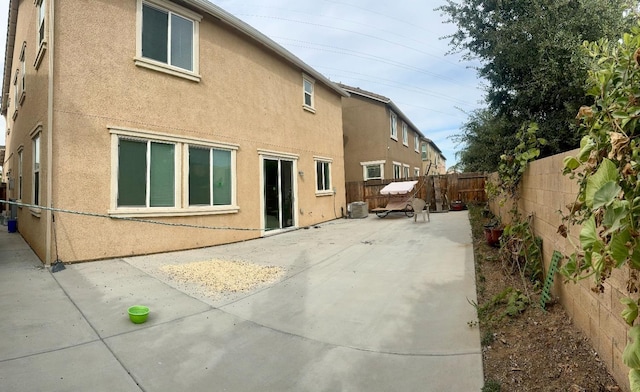 rear view of property featuring a patio area