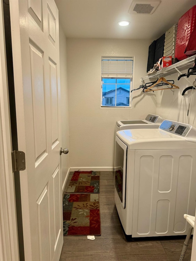 laundry room with washer and clothes dryer and dark hardwood / wood-style floors