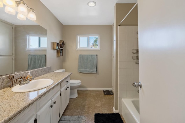 full bathroom featuring tile patterned flooring, tiled shower / bath combo, vanity, and toilet