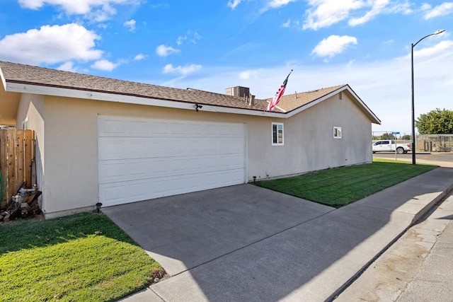 view of side of property with a garage and a yard