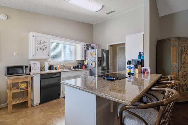 kitchen with a kitchen breakfast bar, black appliances, white cabinetry, and sink