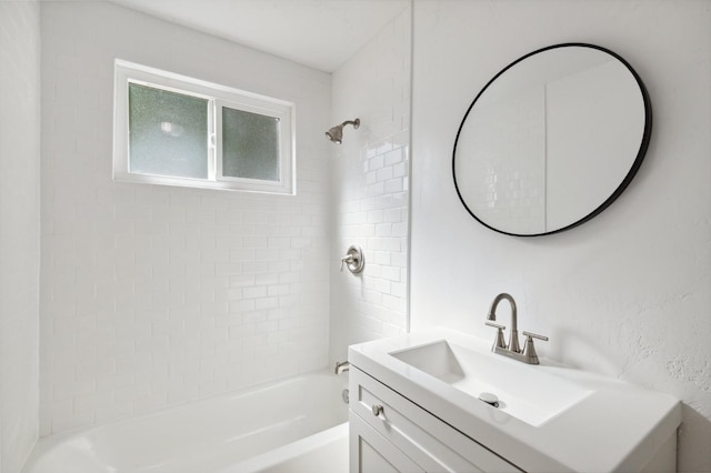 bathroom featuring vanity and tiled shower / bath