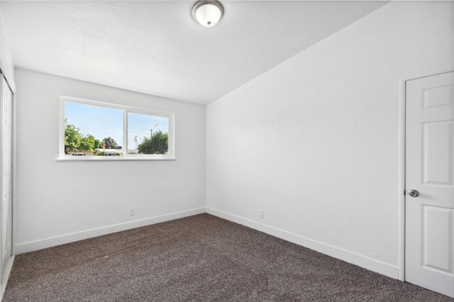 unfurnished bedroom featuring carpet flooring and vaulted ceiling