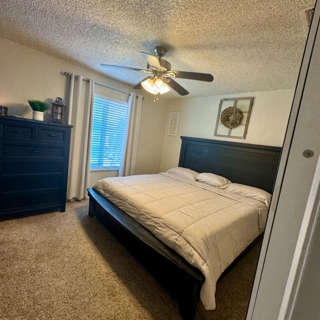 carpeted bedroom featuring a ceiling fan and a textured ceiling