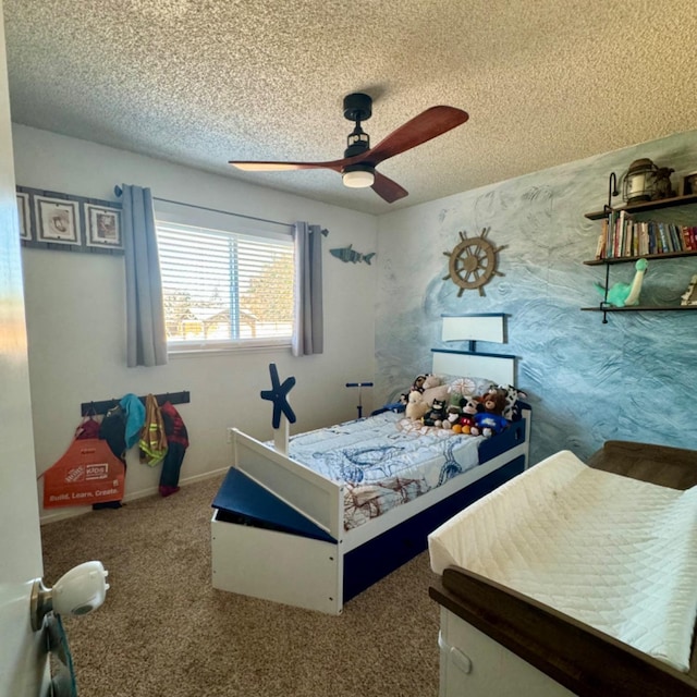 bedroom with ceiling fan, baseboards, a textured ceiling, and carpet flooring