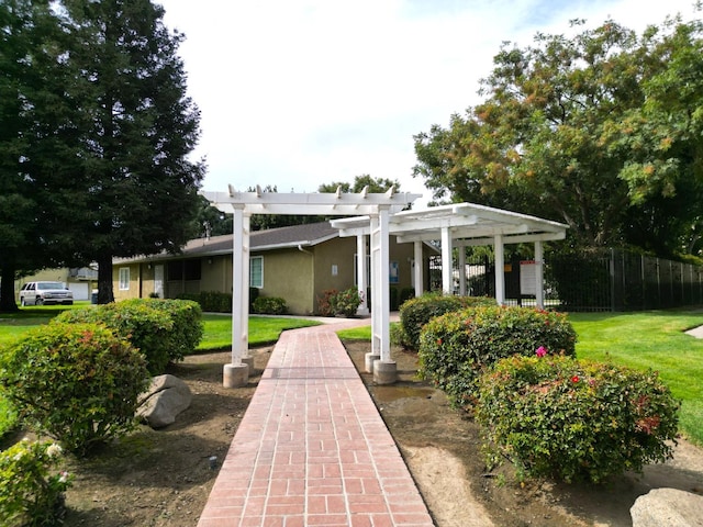 exterior space with a lawn and a pergola