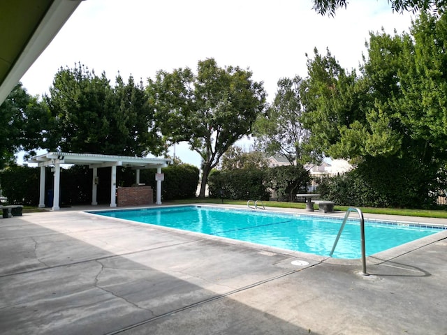 view of pool with a pergola and a patio