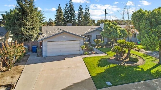 view of front of house featuring a garage and a front lawn