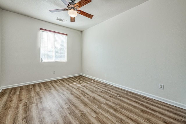 unfurnished room with hardwood / wood-style floors and ceiling fan