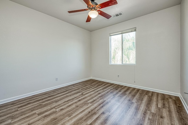 spare room with wood-type flooring and ceiling fan