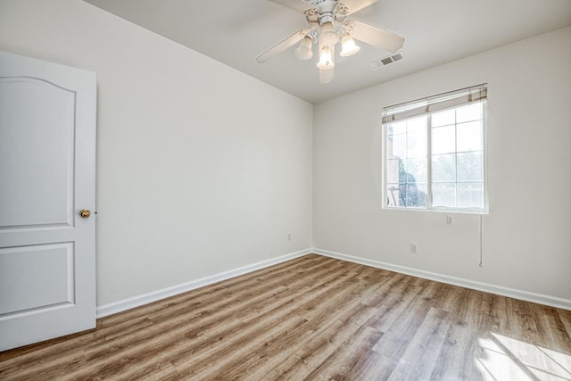 empty room with light hardwood / wood-style floors and ceiling fan