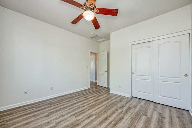 unfurnished bedroom with a closet, light wood-type flooring, and ceiling fan