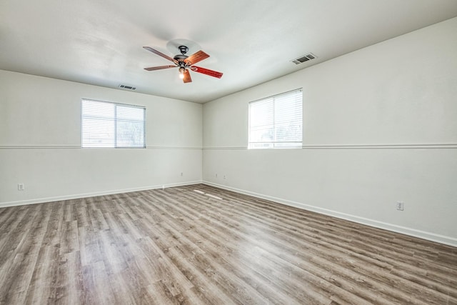 spare room featuring light hardwood / wood-style flooring and ceiling fan