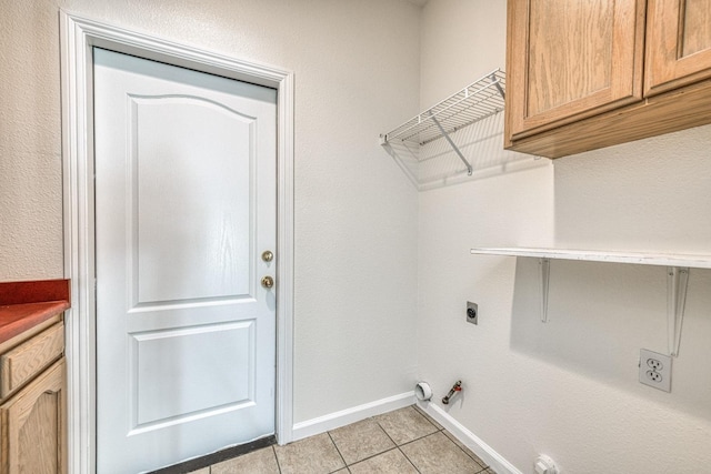 laundry room featuring electric dryer hookup, hookup for a gas dryer, and light tile patterned floors