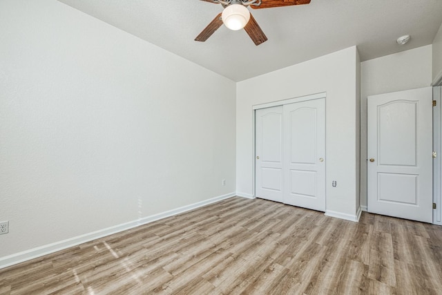 unfurnished bedroom with a closet, light wood-type flooring, and ceiling fan