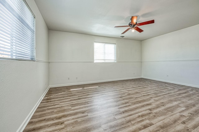 spare room with ceiling fan and wood-type flooring