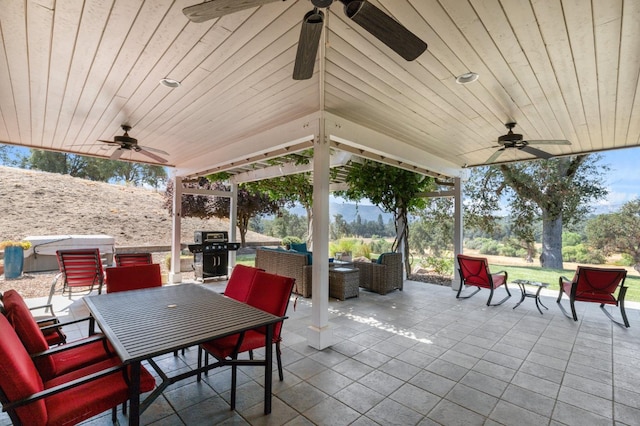 view of patio with ceiling fan, an outdoor hangout area, and a grill