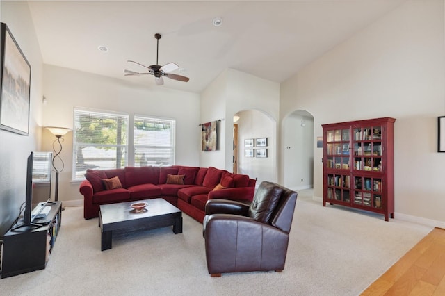 living room featuring lofted ceiling, light hardwood / wood-style floors, and ceiling fan