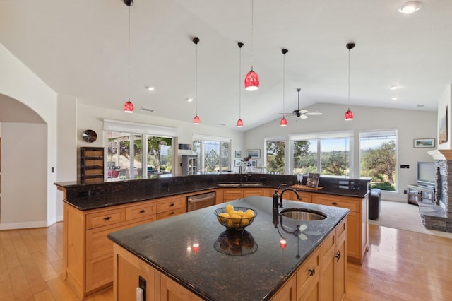 kitchen featuring a large island, ceiling fan, and a wealth of natural light