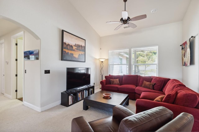 living room featuring ceiling fan, light colored carpet, and lofted ceiling