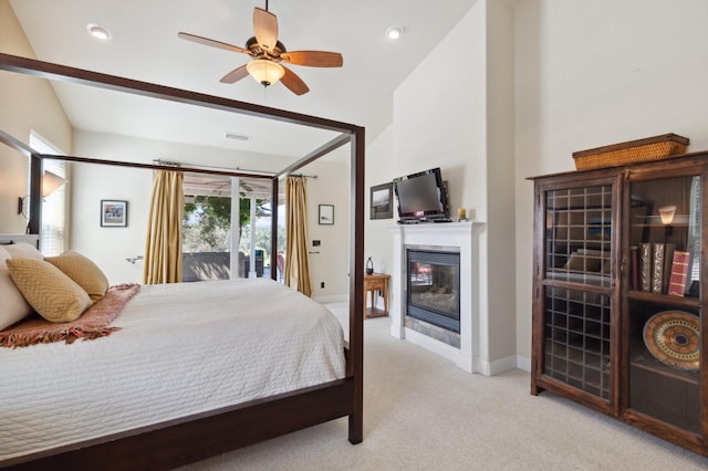 bedroom with access to outside, vaulted ceiling, ceiling fan, and light colored carpet