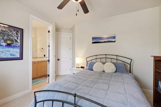 bedroom featuring ceiling fan, connected bathroom, and light carpet