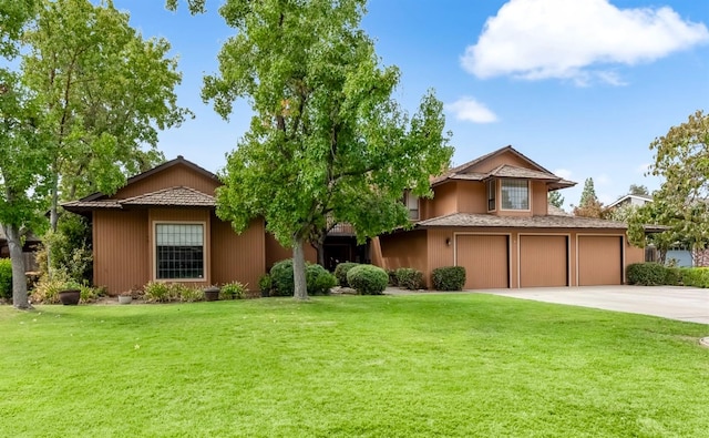 view of front of home with a front lawn and a garage