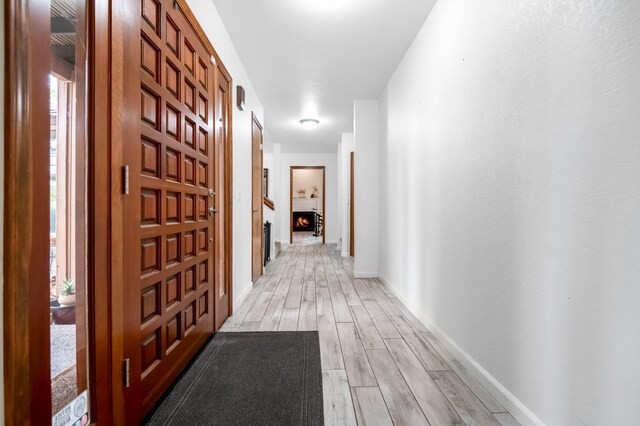 hallway with light wood-type flooring