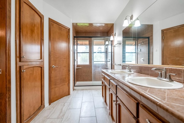 bathroom with tile patterned flooring, a shower with door, and vanity