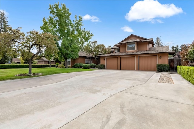 view of front of house featuring a garage and a front lawn