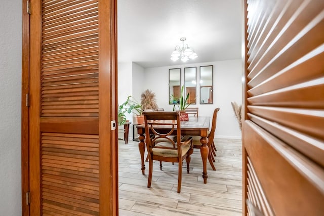 dining space with an inviting chandelier and light hardwood / wood-style floors