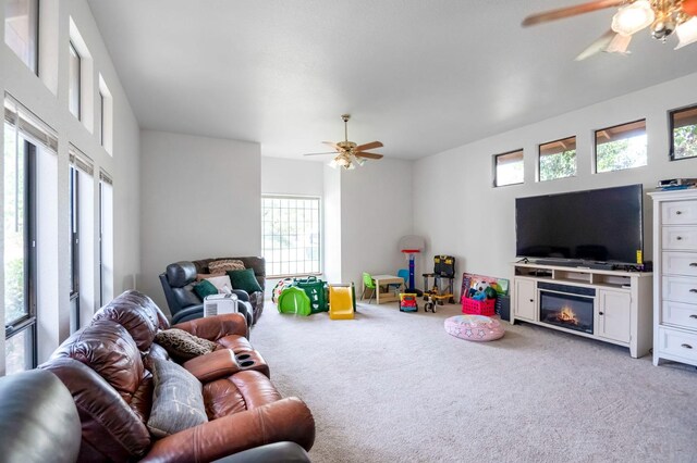 living room with light carpet, ceiling fan, and plenty of natural light