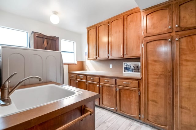 kitchen with light wood-type flooring and sink