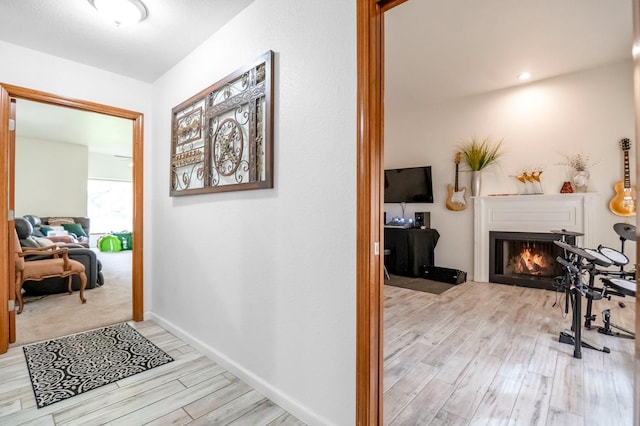 corridor with light hardwood / wood-style floors