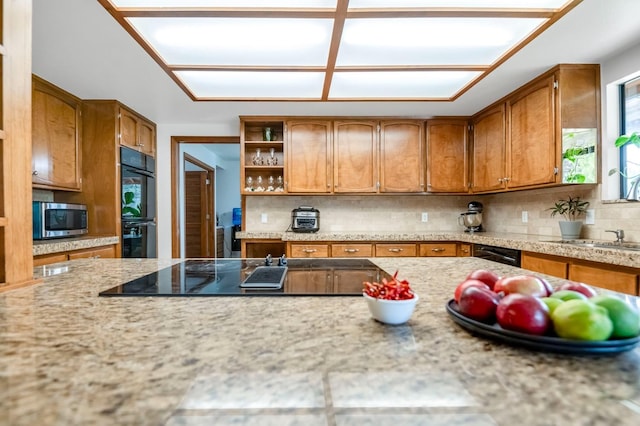 kitchen with decorative backsplash and black appliances