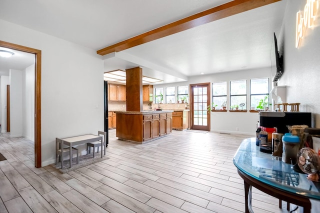 living room with beamed ceiling and light hardwood / wood-style flooring