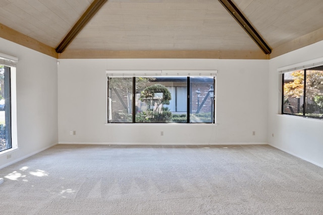 carpeted spare room with lofted ceiling with beams