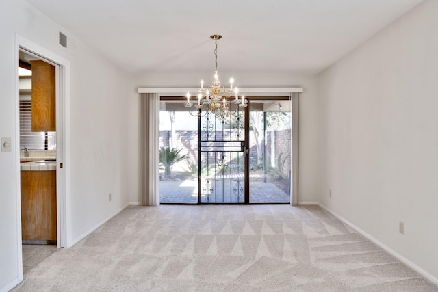 unfurnished room featuring light colored carpet and a notable chandelier