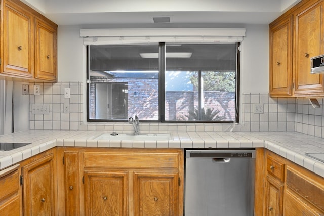 kitchen with tile countertops, sink, and stainless steel dishwasher