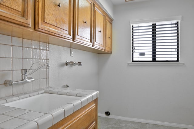 laundry area featuring cabinets and sink