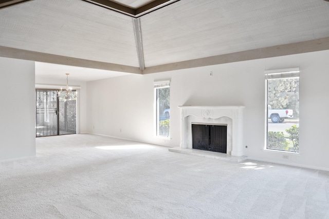 unfurnished living room with an inviting chandelier, a high end fireplace, and carpet flooring