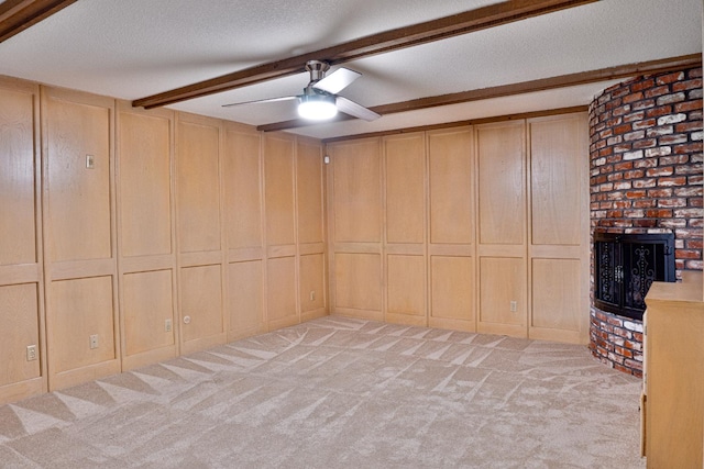 interior space featuring ceiling fan, beamed ceiling, and a textured ceiling