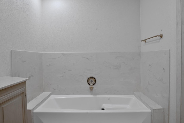 bathroom featuring vanity and a bathtub