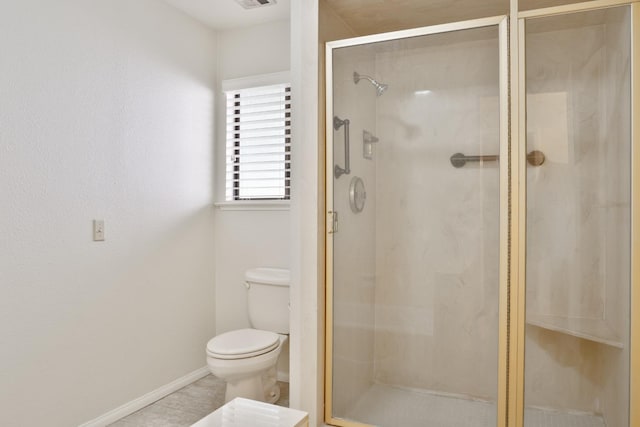 bathroom featuring toilet and an enclosed shower