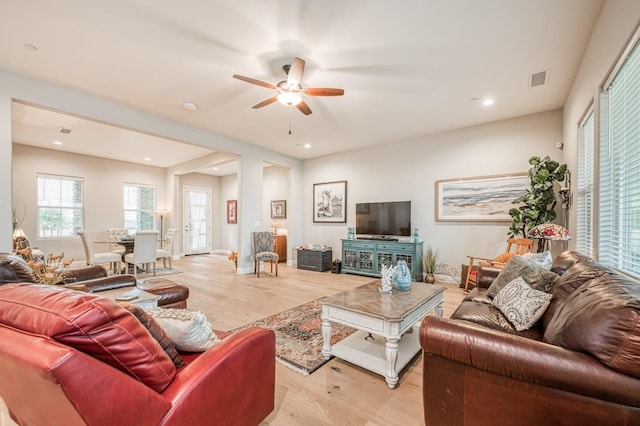 living room featuring light wood-type flooring and ceiling fan