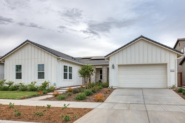 view of front of house featuring a garage and solar panels