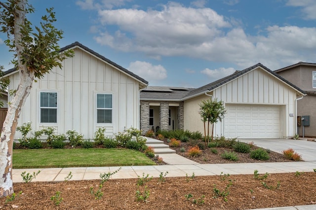 view of front of house featuring solar panels and a garage